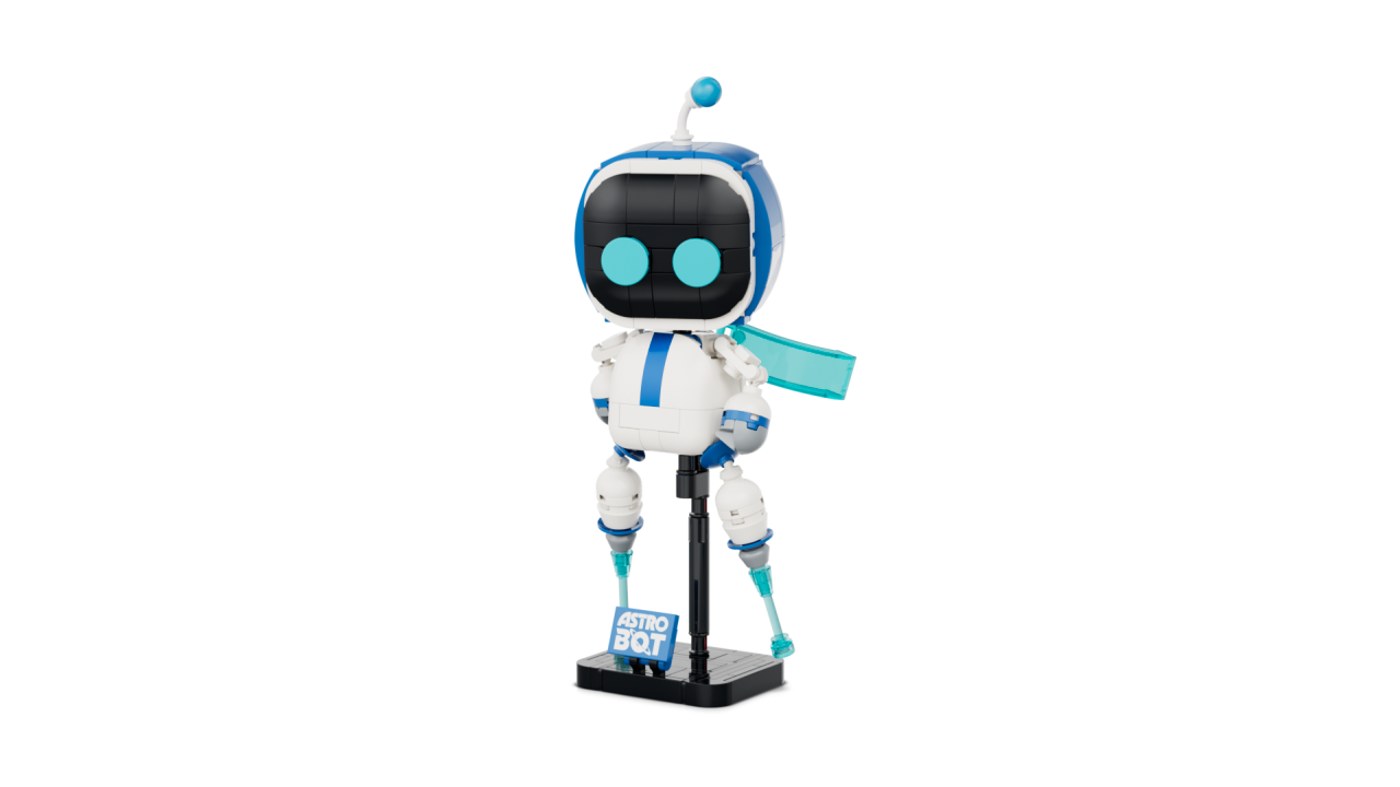 40899 アストロボット。この写真の目は丸型で、三日月型に付け替えられる。背中に水色のマント、足元にネームプレート付きのスタンド（画像: レゴグループ）